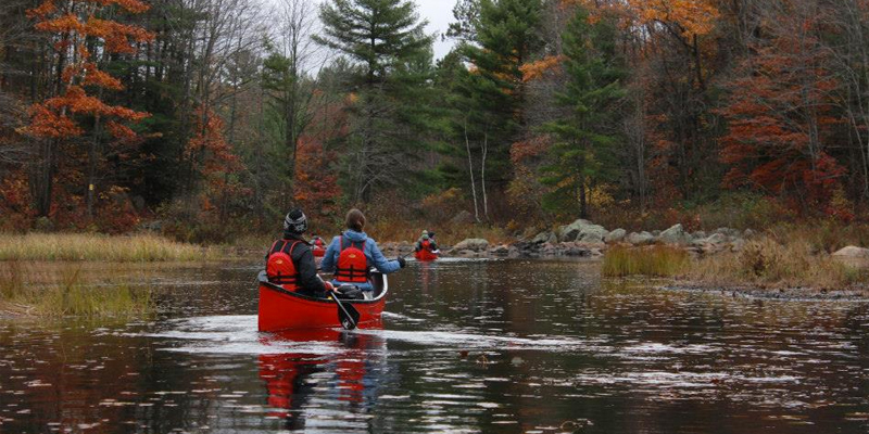 canoeing through lake in fall