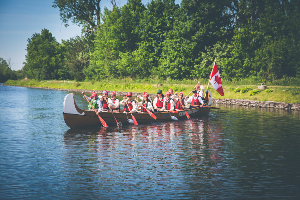 people in a large canoe