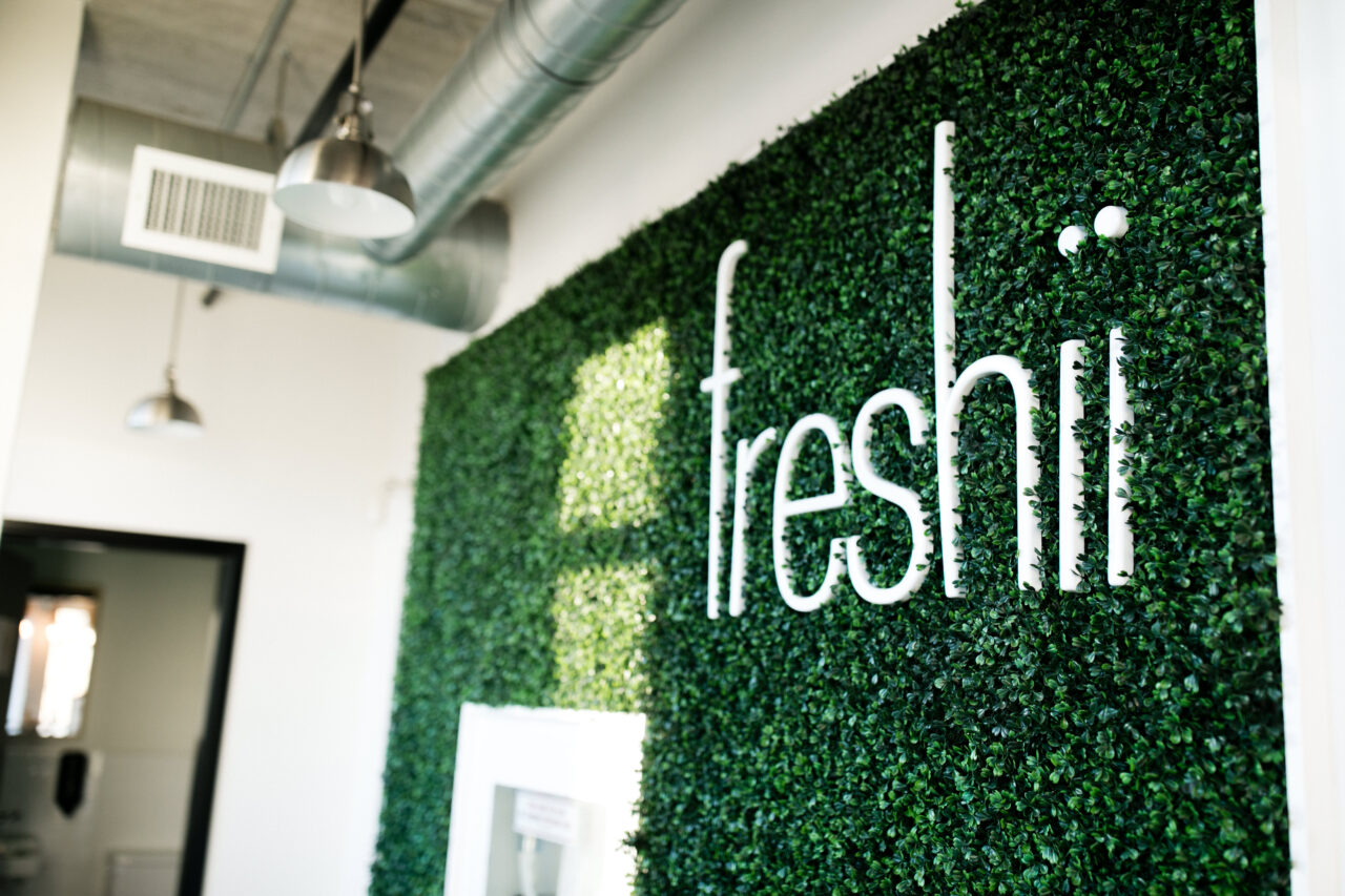 grass wall with word freshii
