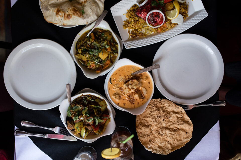 a top down view of a table with Indian dishes