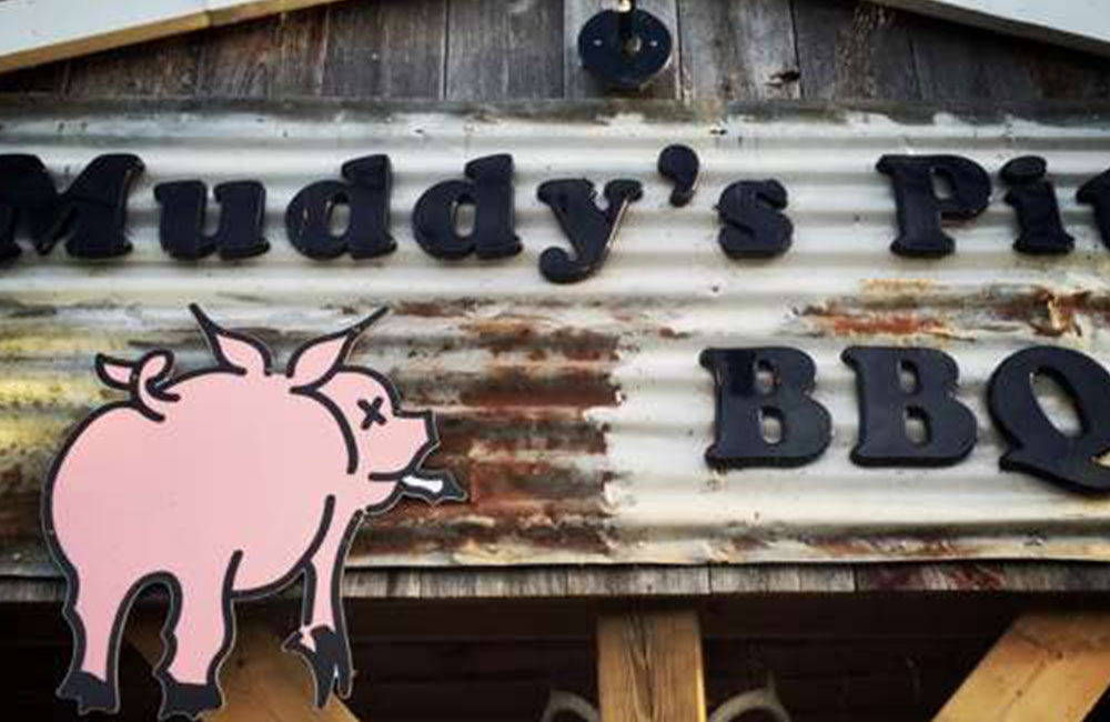 tin store sign with a pig on it