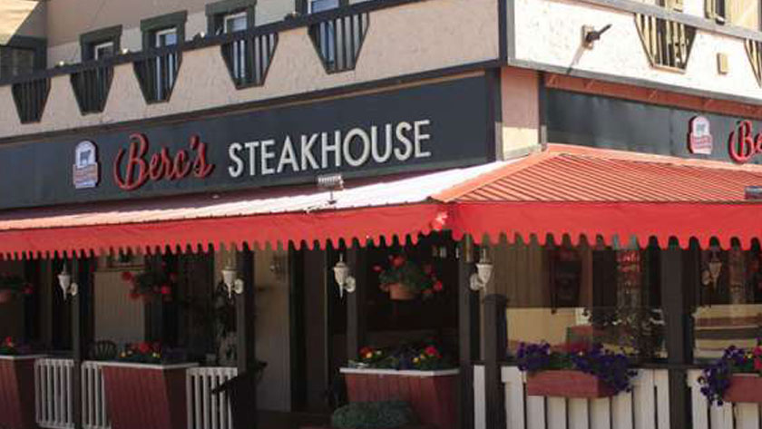 The outside of a steakhouse with a patio