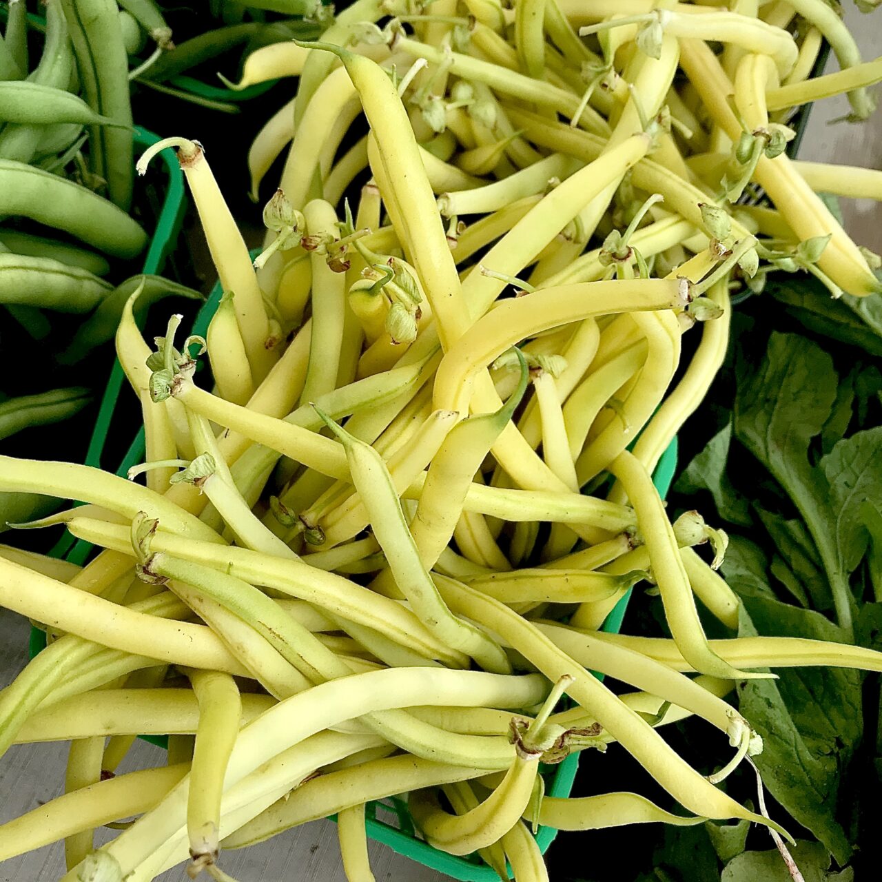 Yellow beans overflowing out of baskets