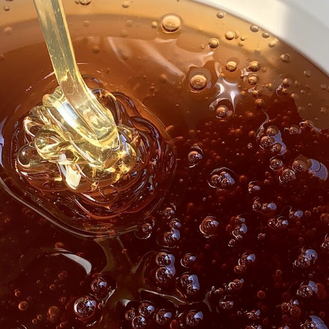 Honey being poured into container