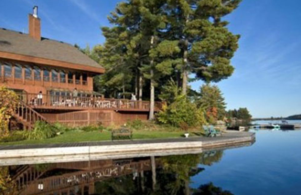 a large wood hotel on a lake