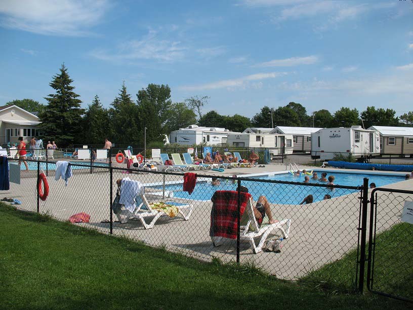 People relaxing and swimming in an outdoor pool