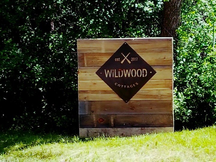 sign displaying wildwood cottages est 2017 on a rustic wooden board