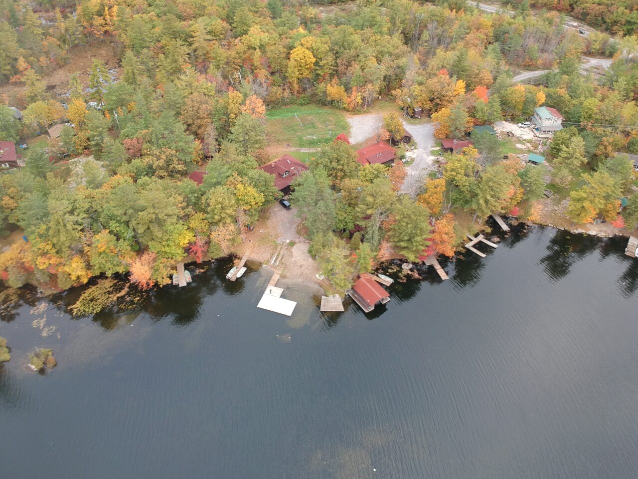 An aerial view of a cottage resort on a lake