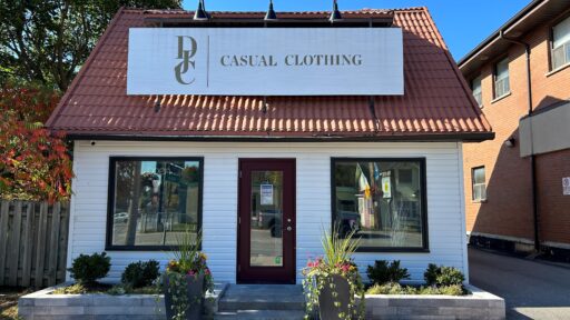 White building, brown roof with a large sign that says "DJC Casual Clothing" - Dan Joyce Clothing Apsley location.