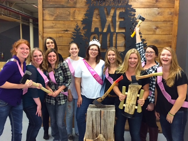 group celebrating a bachelorette's party posing in front of the sign