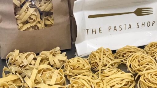 a bunch of pasta balls in front of 2 bags of pasta noodles