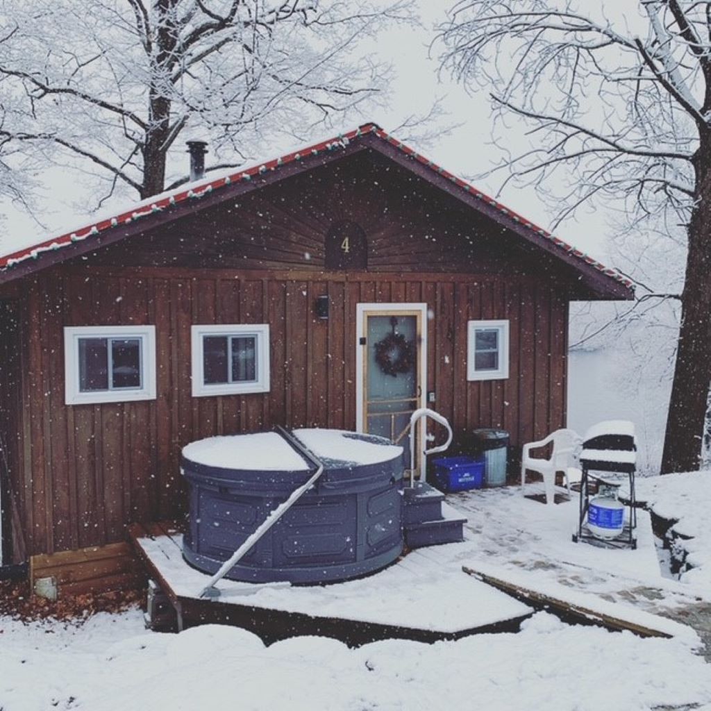 Cottage in winter with hot tub out front