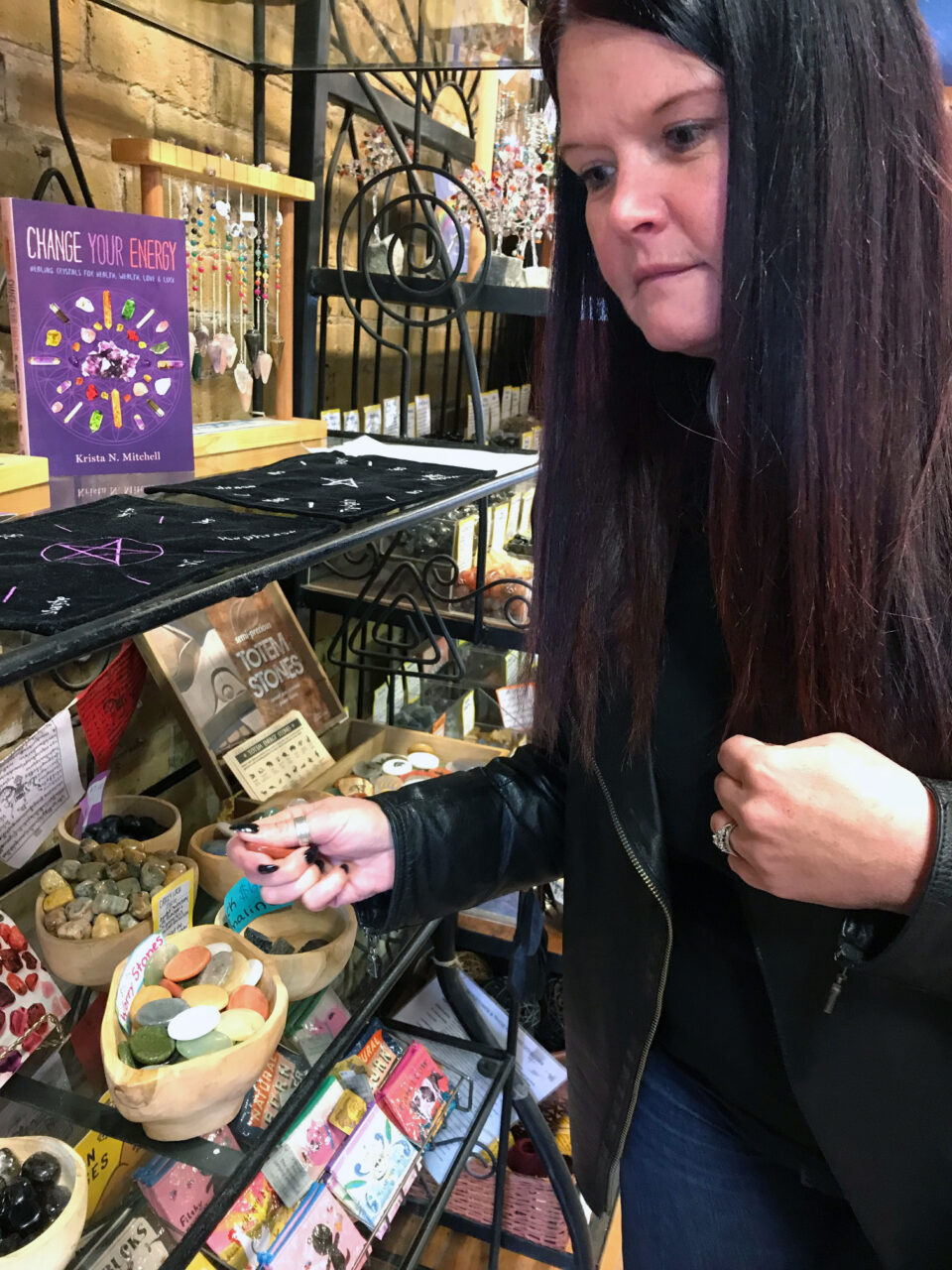 A woman browsing crystals and jewellery for purchase
