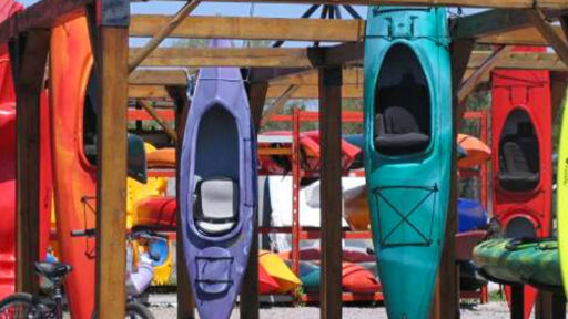 Four kayaks hanging from a rack