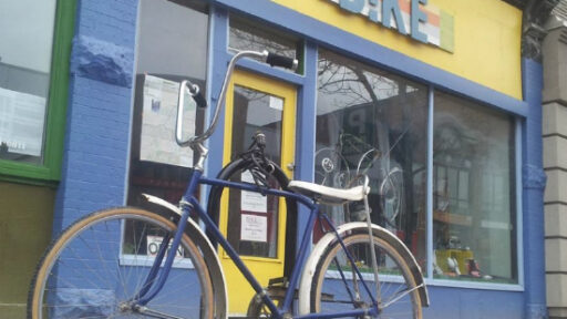 A bike parked in front of a shop