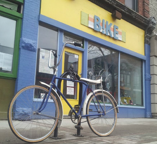 A bike parked in front of a shop