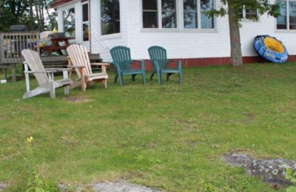 lawn chairs in front of cottage