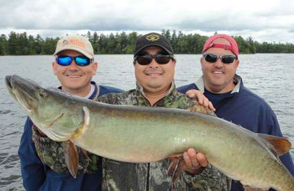 3 men holding a large fish