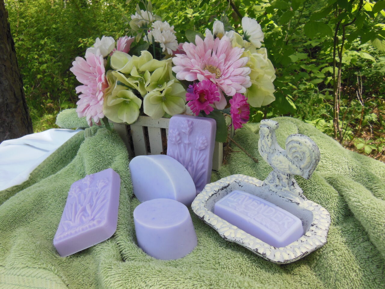 display of soaps and flowers on a towel