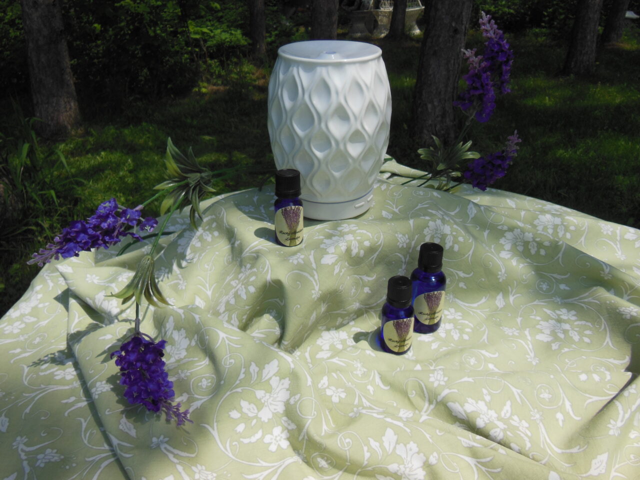 display of essential oil bottles with diffuser and lavender