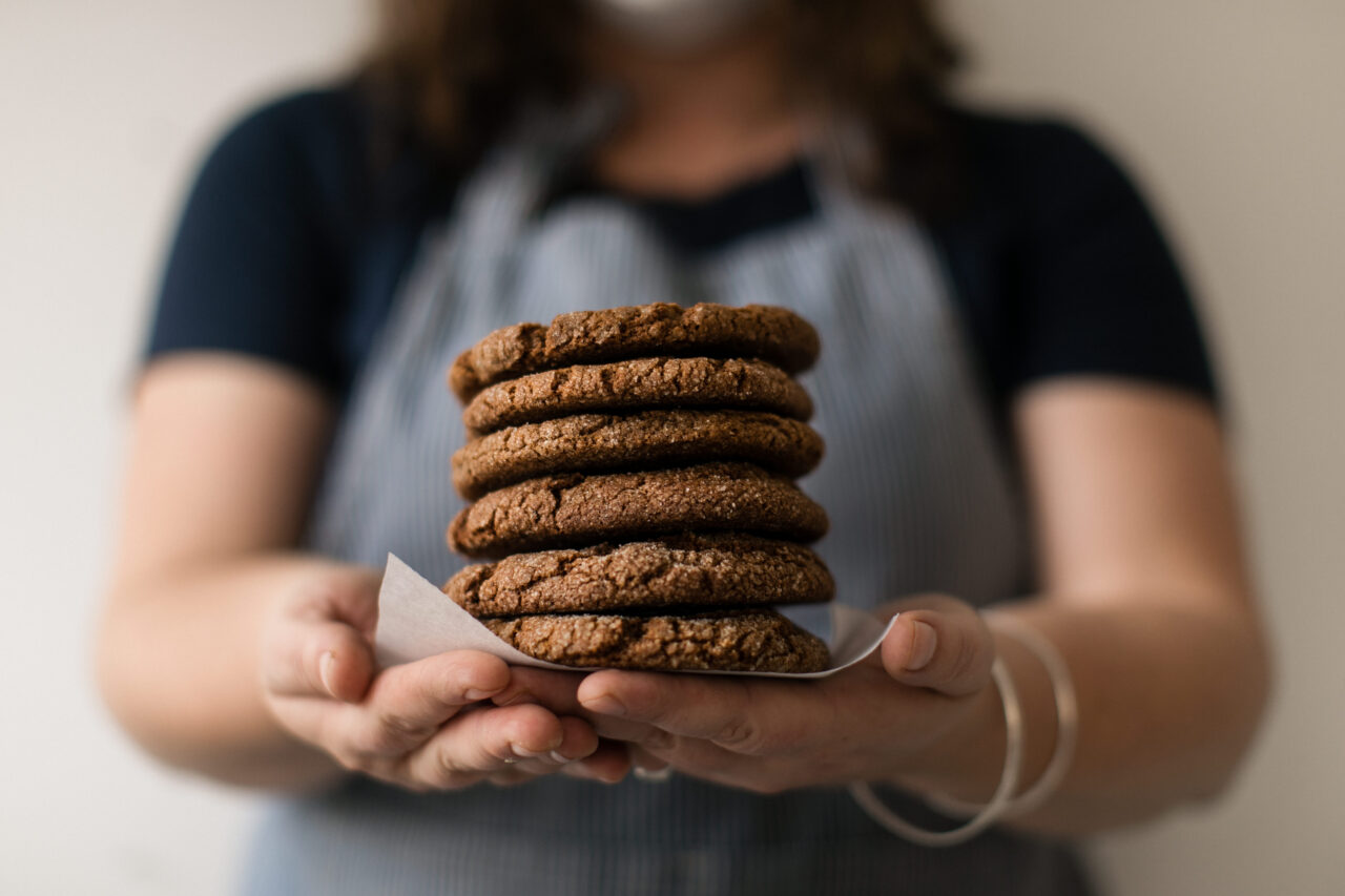A person holds a stack of cookies