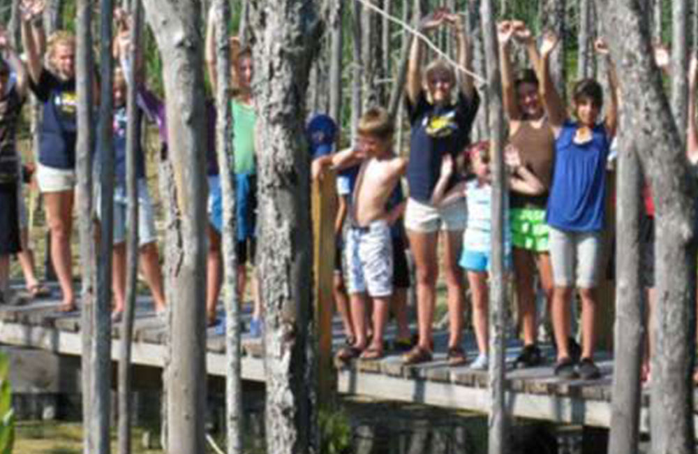 group of children standing on a dock