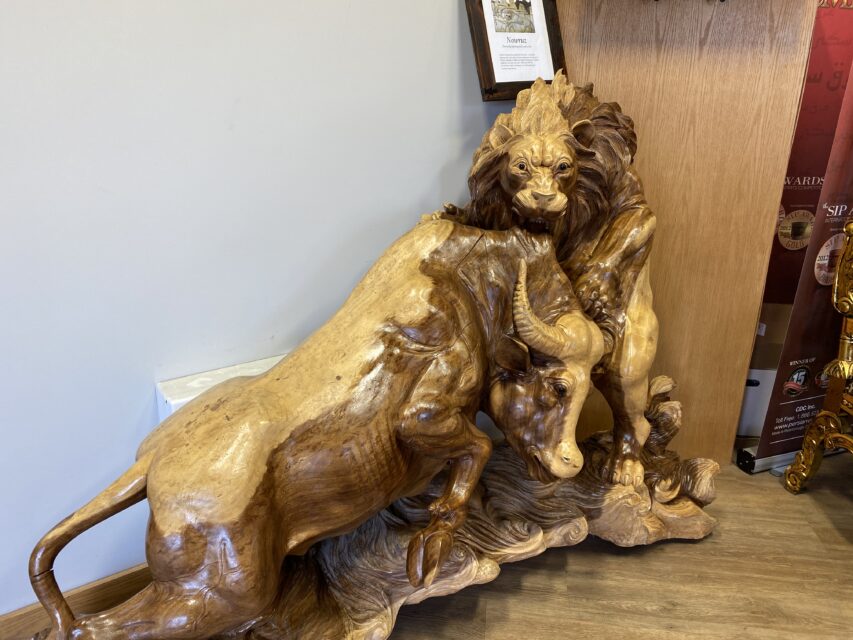 wooden lion and bull statue
