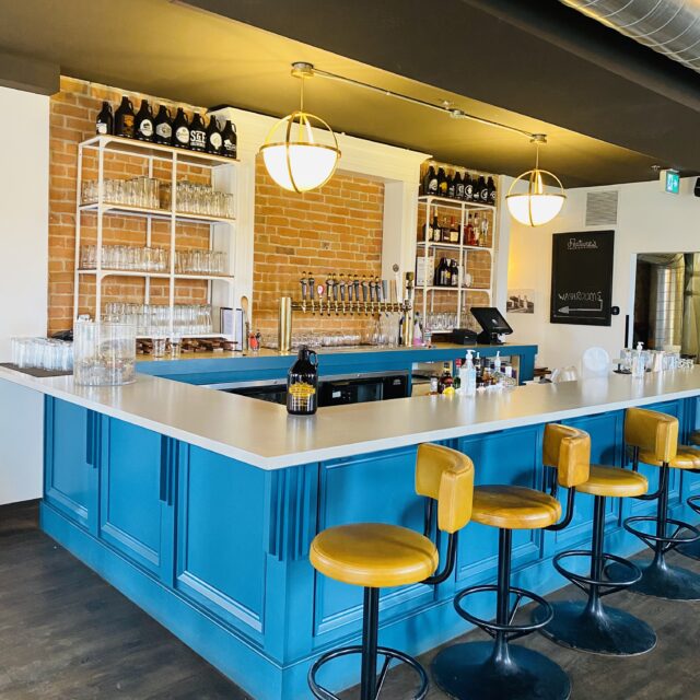 a bar that is blue with yellow stools
