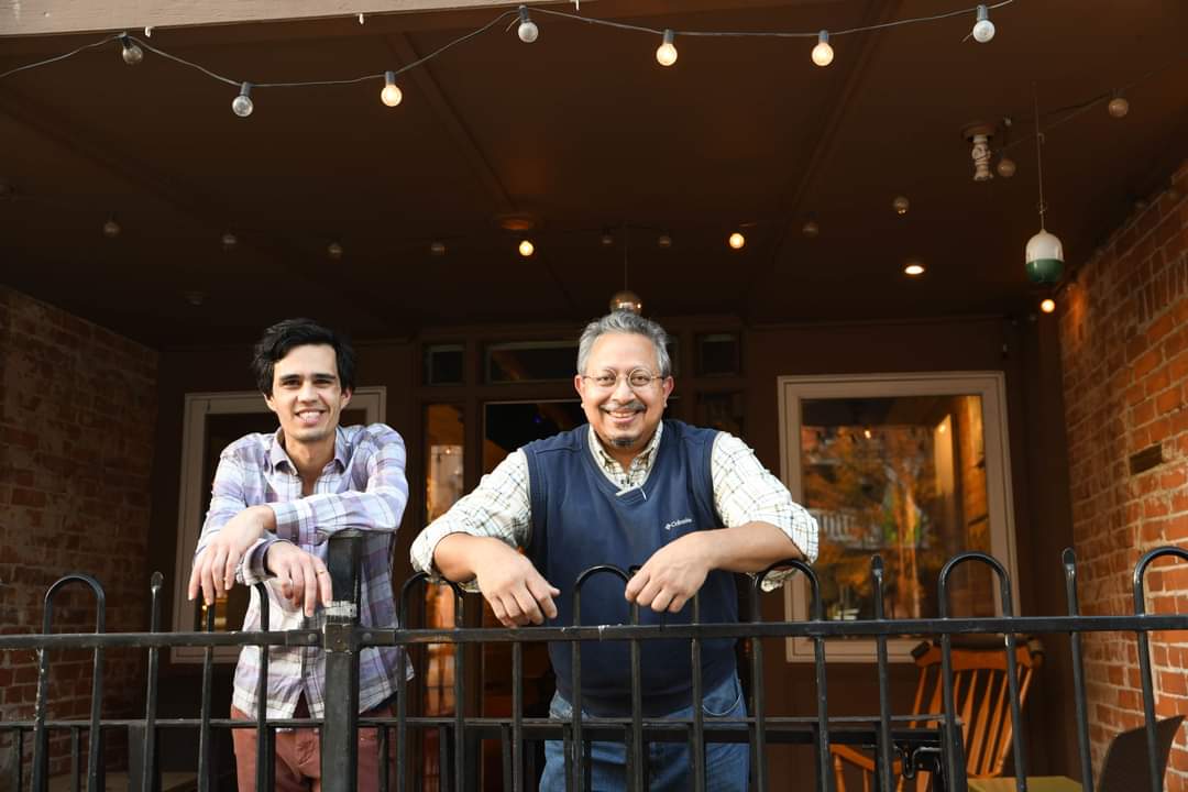 two mens on porch smiling