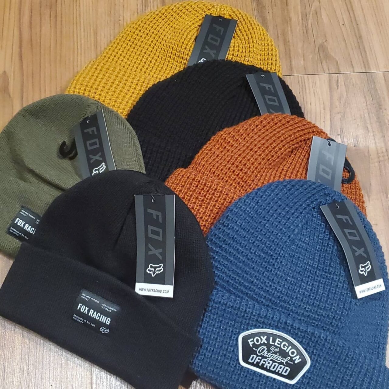 five fox-branded toques