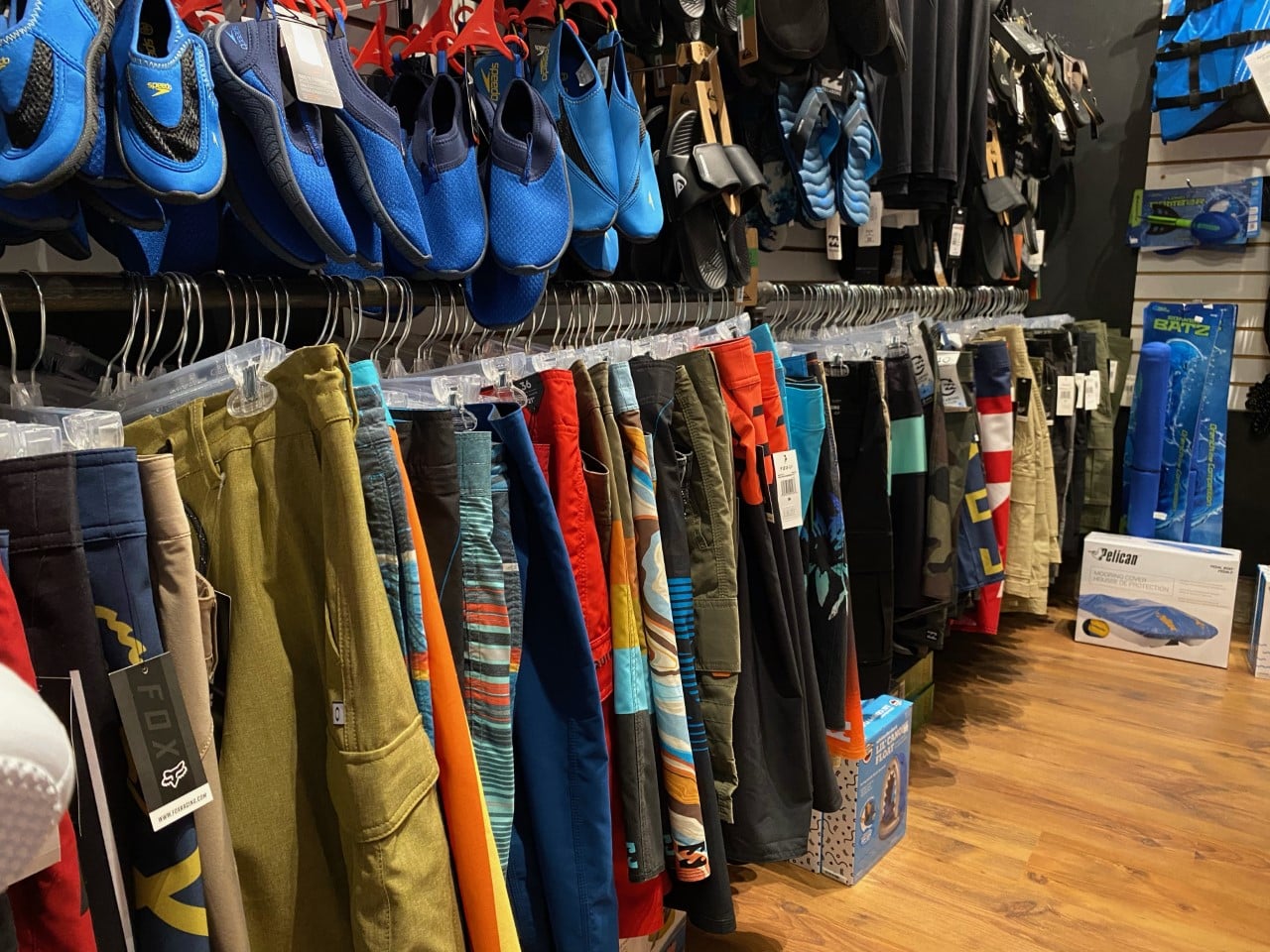 rack of watershoes and boardshorts