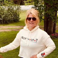 woman in a North of 7 hoodie outdoors