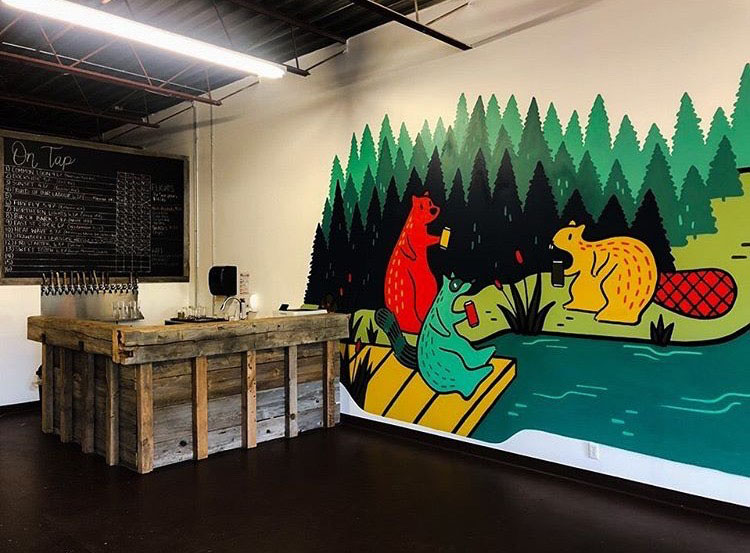 inside store painting of lake and forest on wall