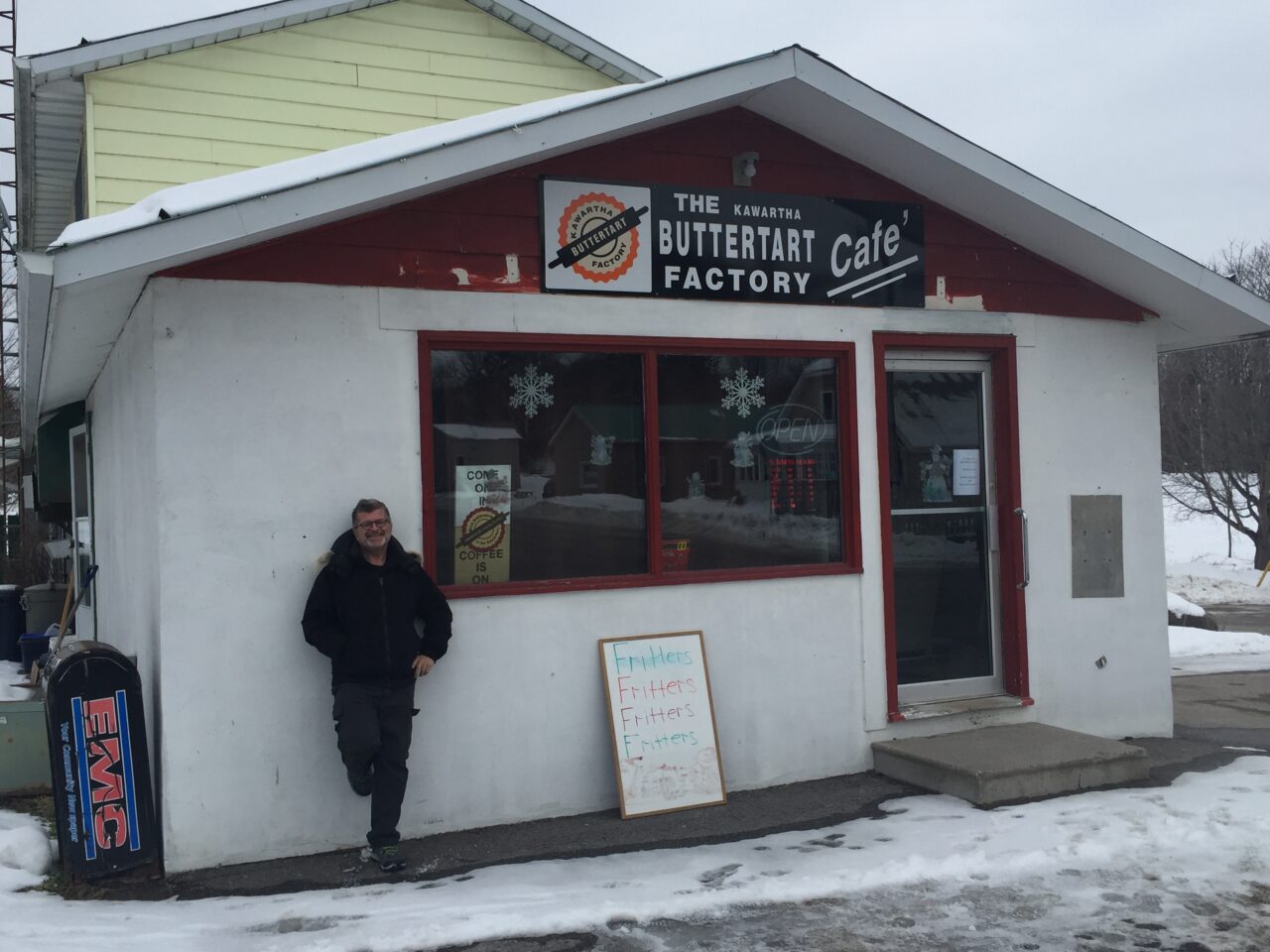 man standing in front of butter tart factory cafe