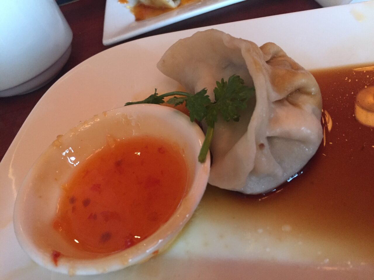 a dim sum with red chilli sauce