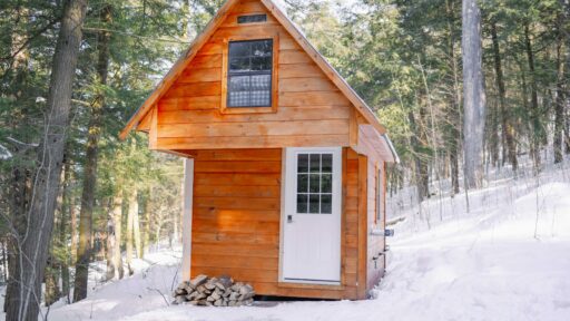 small wood cabin in the woods in winter