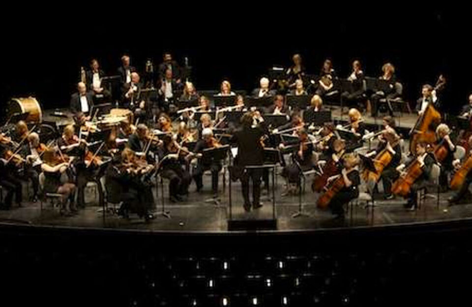 an orchestra playing on a stage