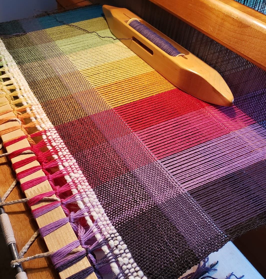 a tapestry being woven on a loom
