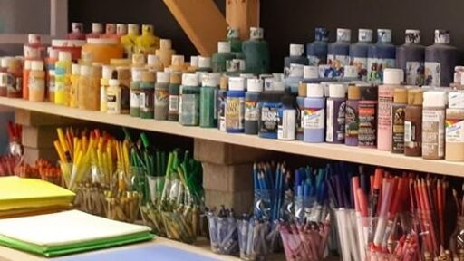 paint bottles and supplies on shelf