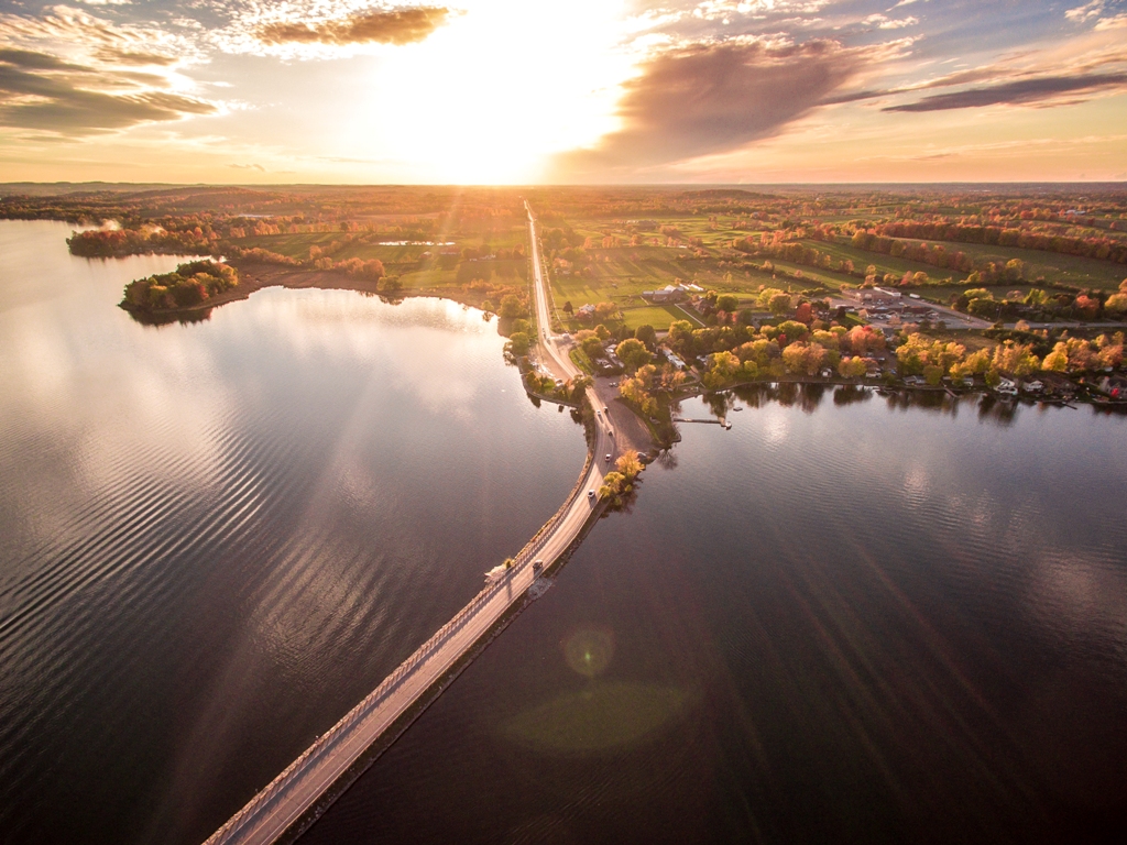 aerial view of a roadway crossing a lake at sunrise