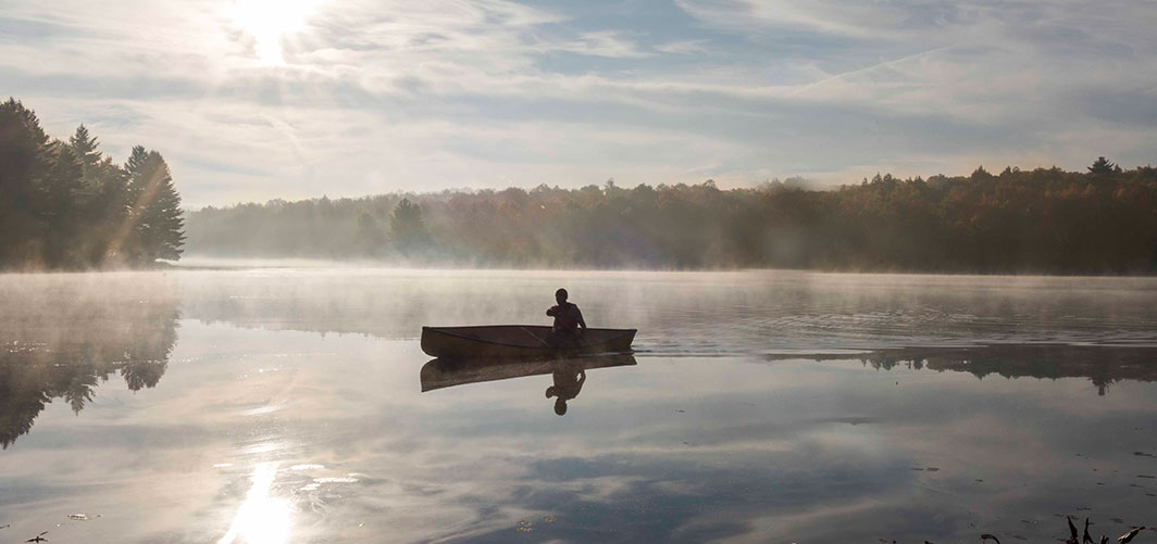 person in a canoe on a lake