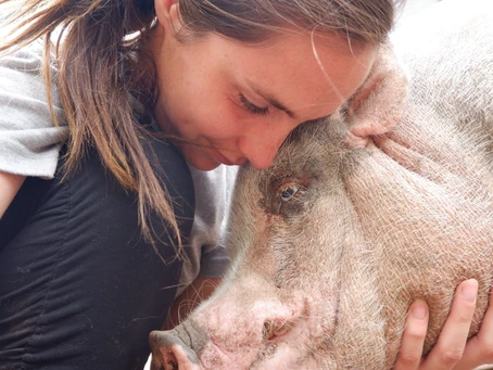 woman hugging a pig