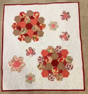 quilt with a geometric flower pattern on it