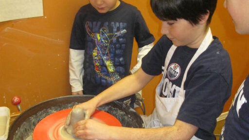 Child creating pottery