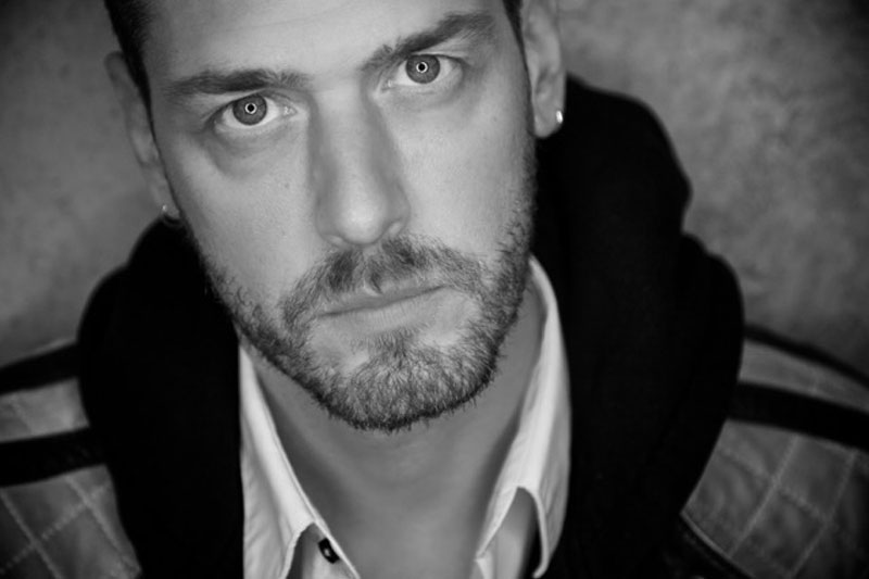 black and white portrait of a person wearing a hoodie