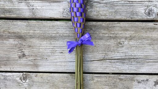 lavender wand/smudging stick on wood background