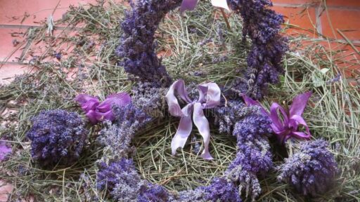 two wreaths made out of dried lavender with purple bows