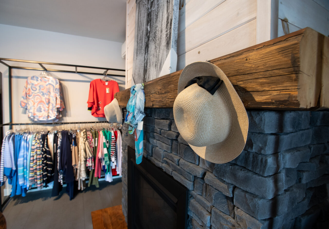 Hack rack placed over decorative fireplace inside Dan Joyce Clothing store in Apsley