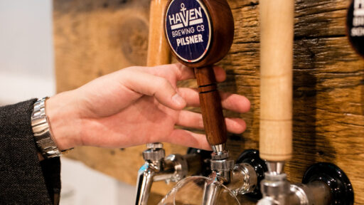 an image of a person pouring a beer from a beer tap