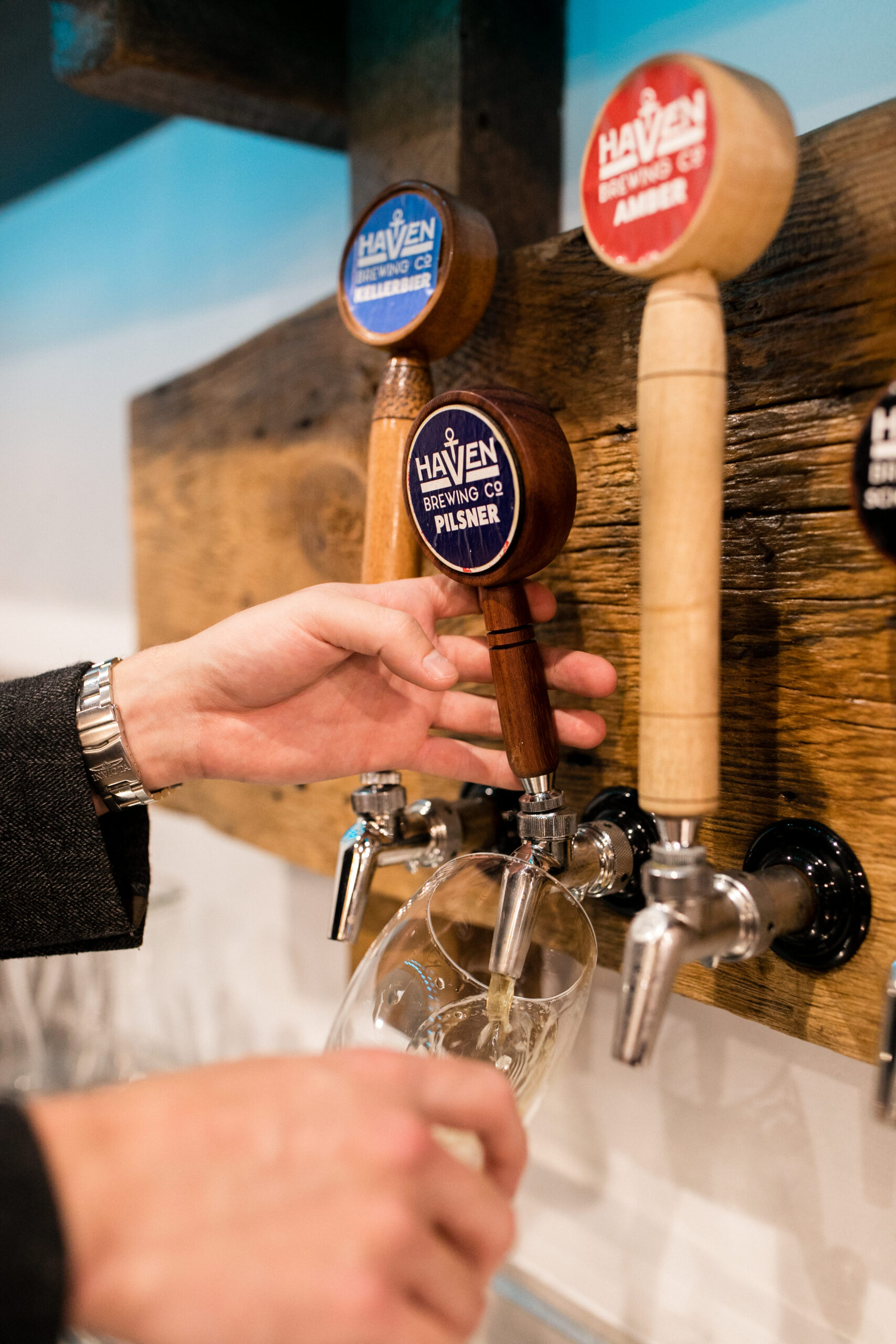 an image of a person pouring a beer from a beer tap